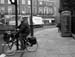 Russell Square man, bicycle, double decker nd call box in black and whie (British Grey)